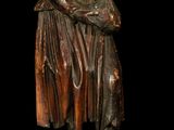 bronze statue of a woman holding a basket on a black background