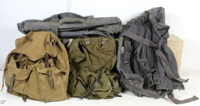 three backpacks are lined up on top of each other on a white surface