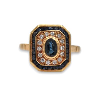 a close up of a gold ring with a blue sapphire and white diamonds