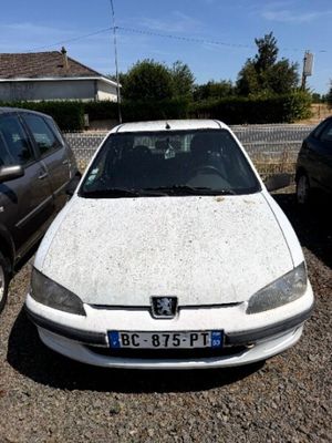 a white car parked next to a black car in a parking lot