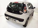 a small white car that is parked in a room