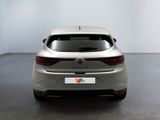 the rear end of a silver car in a room with a white wall