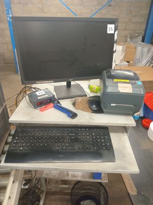 a computer desk with a keyboard and a monitor on it