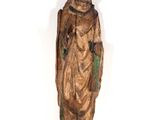 an old wooden statue of a man with a beard and a hat
