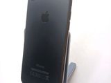 a black iphone that is sitting on a stand