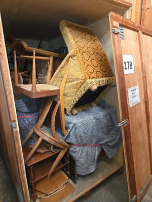 a small room with a bed and a chair in it