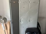 a stack of lockers and a chair in a room