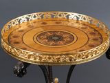 a gold and black tray on a stand on a gray background