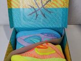the shoe box is full of colorful shoes and a pair of sneakers