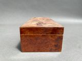 an old wooden box sitting on top of a gray surface