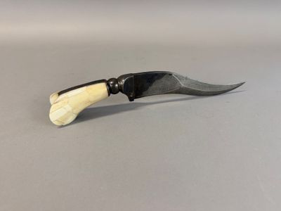 a small knife with a black handle on a table