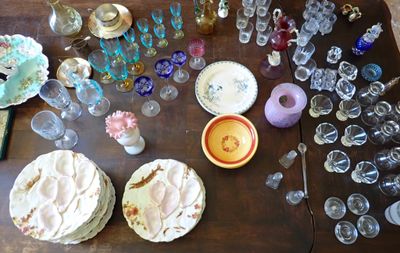 a wooden table with a lot of glassware on it