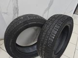 two tires are sitting on a tiled floor in front of a wall