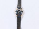 an image of a watch on a white surface with a black strap