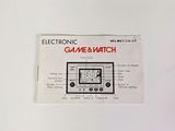 an electronic game and watch on display on the wall
