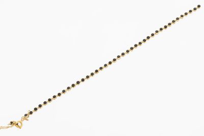 an image of a gold chain with a black bead on a white background