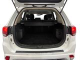 the back end of a white suv with its trunk open