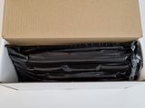 a cardboard box with a bunch of black plates inside of it
