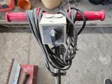 a red handlebar attached to the handle of a bike