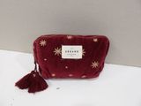 red velvet pouch with gold stars and tassels on it