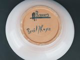 a white bowl with a brown label on it