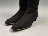 a close up of a pair of black boots on a white surface