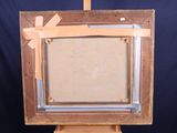 an old wooden easel with a painting on top of it