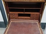 an antique writing desk with a leather top and gold trimming