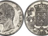 a silver coin with a crown on top of it