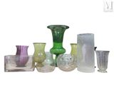 many different colored glass vases sitting on a table