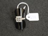a silver ring with a flower on it and a price tag