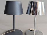 pair of black and silver table lamps on a white surface
