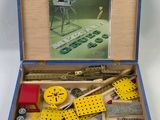 a wooden box with tools in it on a white surface