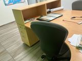 a desk with a chair and a computer on it