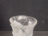 a glass cup with a spoon in it sitting on a table