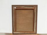 an old picture frame sitting on top of a table next to a white wall
