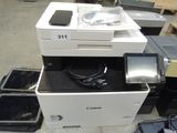 a printer and a cell phone sitting on top of each other