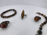 three pieces of jewelry are displayed on a white surface