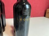 three bottles of wine sitting on a table