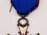 a close up of a medal with a cross on it