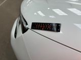 a sticker on the hood of a white car