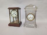 two clocks sitting next to each other on a table