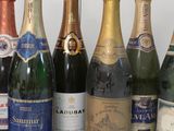 several bottles of wine are lined up on a table