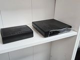 two black speakers on a white shelf in a room