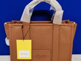a brown handbag with a yellow tag on it