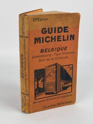 un vieux livre posé sur une table à côté d'un fond blanc