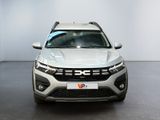 the front view of a white suv parked in a showroom