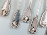 six spoons that are sitting next to each other on a table