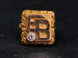 an image of a gold and diamond ring with the letter b