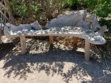 a stone bench sitting in the middle of a garden